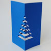 blaue Weihnachtskarten mit Weihnachtsbaum zum Falten für den Schreibtisch